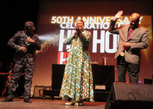 Roxanne Shanté center stage with Berklee College's Dean of Africana Studies Dr. Emmett G. Price III right, Ph.D. and Public Enemy's Flava Flav left